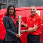 President of Commonwealth Games England Denise Lewis receives the Queen's Baton from local postie Dave Hoskin.jpg